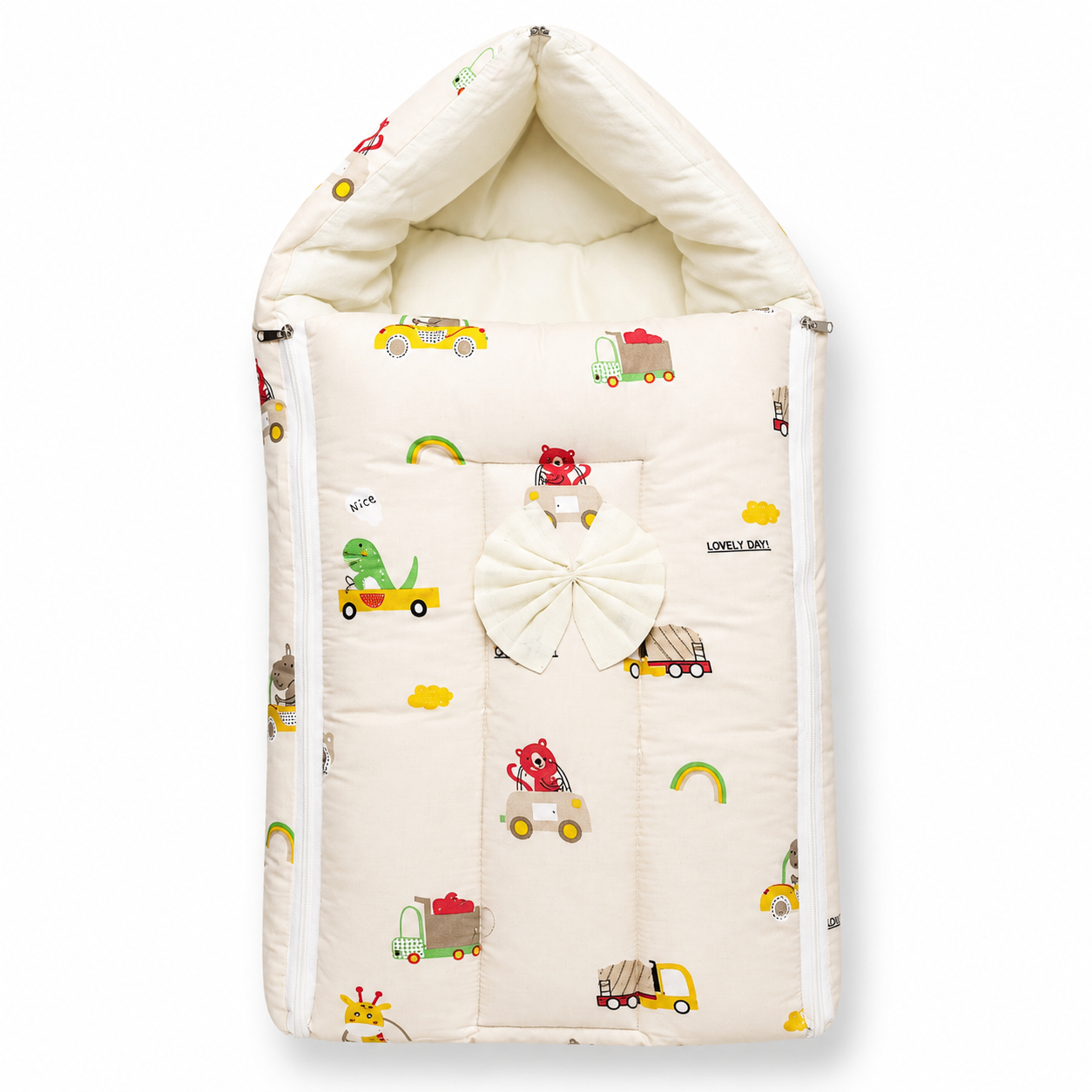 A quilted baby bassinet cover with a hood, featuring a cream-colored background with a playful pattern of colorful toy cars, a green dinosaur, and a large white bow on the front.
