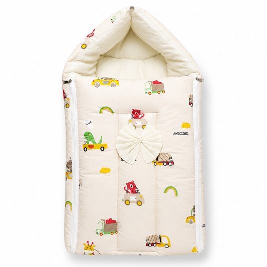 A quilted baby bassinet cover with a hood, featuring a cream-colored background with a playful pattern of colorful toy cars, a green dinosaur, and a large white bow on the front.