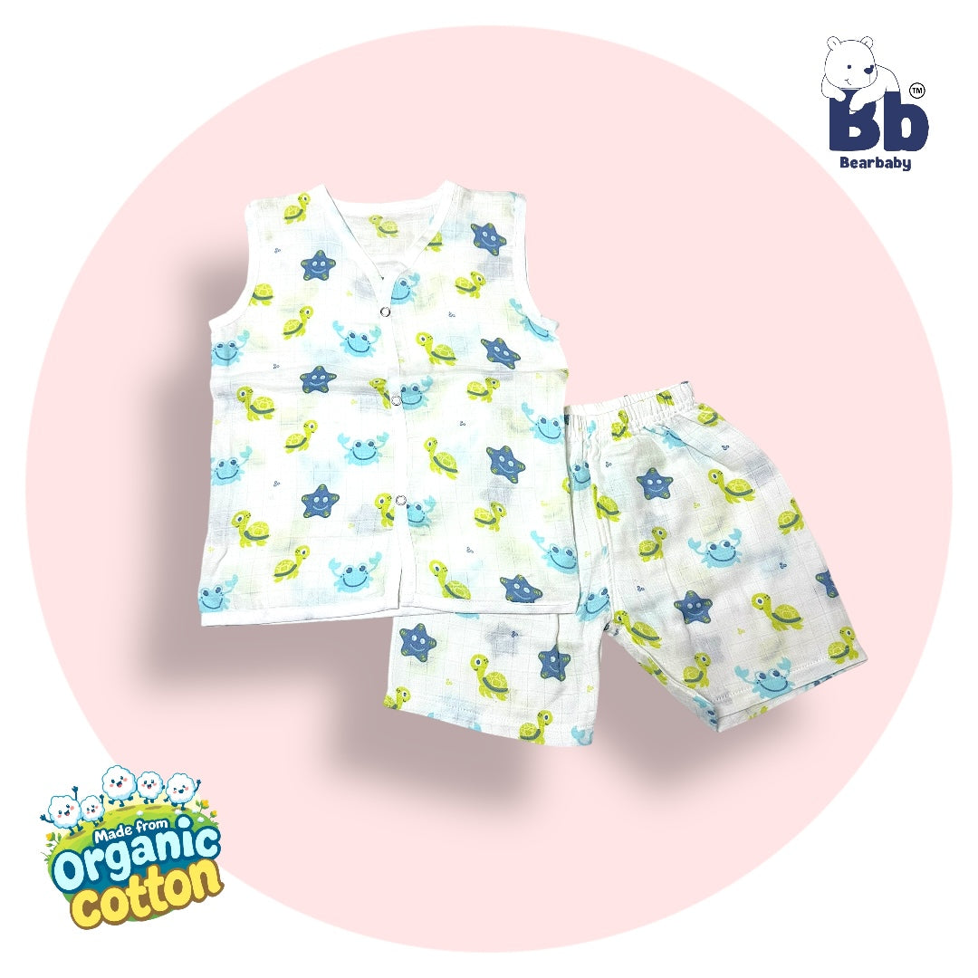 A set of baby clothing, featuring a sleeveless muslin top with a star print and matching shorts, presented on a white background with a graphic indicating organic cotton. Sleeveless Jhabla and Pajama