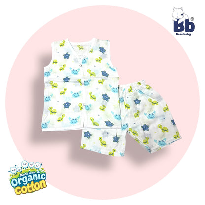A set of baby clothing, featuring a sleeveless muslin top with a star print and matching shorts, presented on a white background with a graphic indicating organic cotton. Sleeveless Jhabla and Pajama