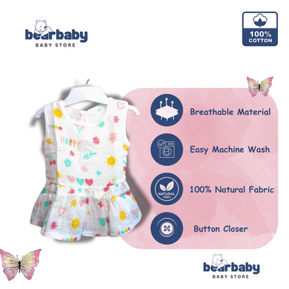 Bear Baby organic cotton baby girl frock, white with assorted prints of suns, hearts, and flowers. Sleeveless with a peplum hem.