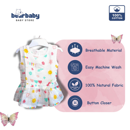 Bear Baby sleeveless organic cotton frock for baby girls, white with assorted prints of suns, hearts, and flowers. Button closure.