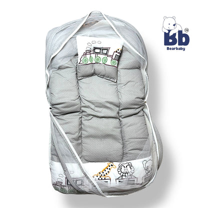 A gray baby bed with thick mattress, mosquito net, and neck pillow, featuring animal character designs and a zip closure.