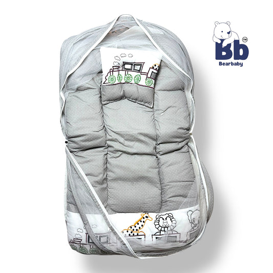 A gray baby bed with thick mattress, mosquito net, and neck pillow, featuring animal character designs and a zip closure.